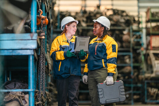 Two Female Technicians Inspecting Automotive Parts