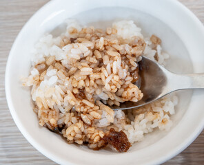 Braised pork belly meat over cooked rice.