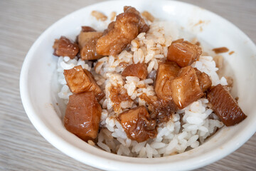Braised pork belly meat over cooked rice.