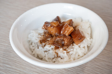 Braised pork belly meat over cooked rice.