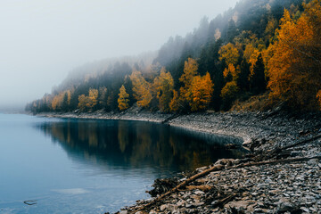 Sant Maurici Lake with Rocky Shore, Turquoise Waters and Misty Forest, Aiguestortes, Spain