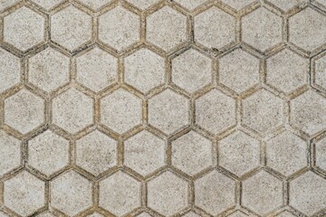 Top Down View of Old Weathered Hexagonal Concrete Paving Stones Forming a Geometric Honeycomb Pattern