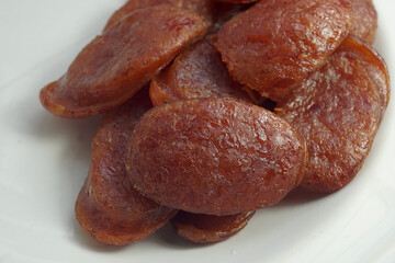 Fried Chinese sausage sliced pieces Asian food closeup