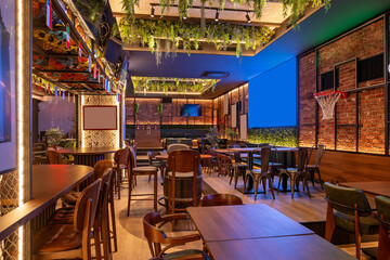 Interior of a sport cafe featuring brick walls and several TV screens