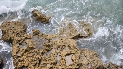Ocean Waves and Textured Coastal Rocks