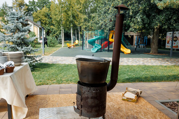 The ukha is being cooked in a large cauldron.
