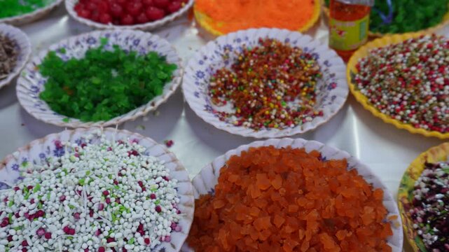 Colorful Indian mukhwas and sugar coated fennel seeds displayed in plates