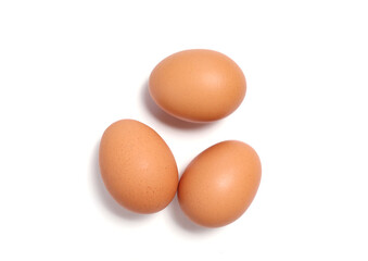 Three brown chicken eggs isolated on white background. Suitable for organic food, protein, and healthy lifestyle themes. Perfect for cooking, nutrition, natural farming, clean eating design concepts.