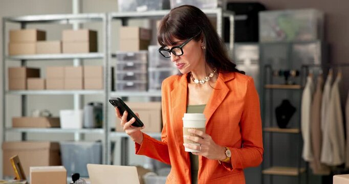 Startup, coffee and woman with smartphone, logistics and reading reviews on social media and online. Drinking, caffeine and mature person with mobile for feedback, happy and boxes in small business
