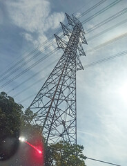 ​Low Angle View of Electricity Pylon with Sun Flare