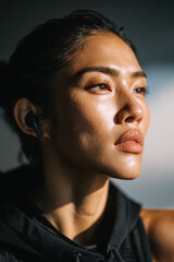 Close-up of Asian woman sport girl wearing athletic outfit, confident look and natural light, showing strength, health, and active lifestyle concept.