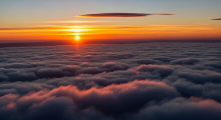 Dramatic sunset above the clouds orange sky and horizon view