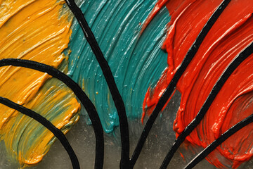 Vivid colors and bold brush strokes create an abstract art piece full of energy and creativity in a vibrant studio setting