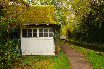 Old Mossy Canal Cottage Beside Bridge in English Countryside