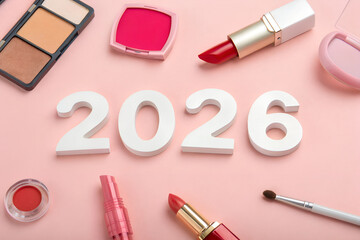 Beauty trends 2026 with makeup products on pink background, featuring lipstick, brush, blush, eyeshadow palette, compact mirror, and bold white numbers generative ai