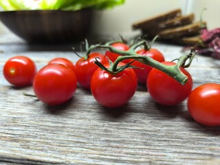 cherry tomatoes lie on a wooden table