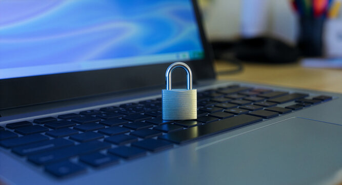 Padlock on laptop keyboard digital security