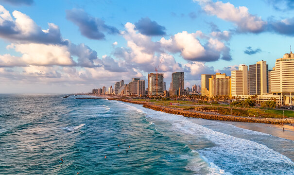 Aerial view of a vibrant coastline where the turquoise sea meets the golden sands under a dramatic sky, Old Jaffa, Tel Aviv-Yafo, Israel.