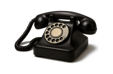 Classic black rotary dial telephone with coiled cord isolated on a dark background vintage communication device