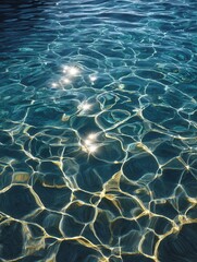 A close-up view of clear water with sunlight creating sparkling reflections. Ideal for nature and relaxation themes.