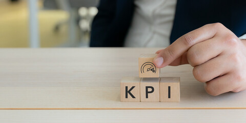 KPI and business performance indicator. Measuring productivity and strategic success. Wooden cube blocks with KPI letters and performance icon. Key performance indicators  and goal management.