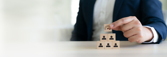 Soft Skills and Leadership concept. Building a team with emotional intelligence. Wooden blocks with emotional intelligence performance icon. Soft skills, leadership and empathy in workplace.