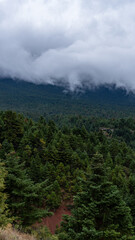 Dramatic Mountain Landscape with Road and Cloud-Kissed Peaks