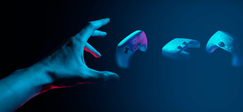 gamer hand touching and interactive to holographic of gaming joystick controller, game and esports technology