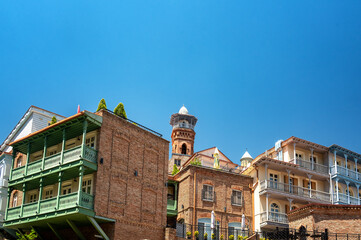Beautiful historic architecture with balconies and the Juma Mosque visible in the historic center of Tbilisi, Georgia