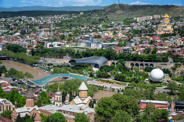 Beautiful view of Tbilisi, Georgia with the Bridge of Peace spanning the Kura River © jkraft5