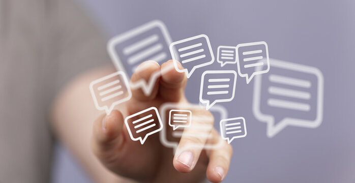 An image of a hand touching floating message bubbles, conveying communication, technology, and social connection. Ideal for social media, market
