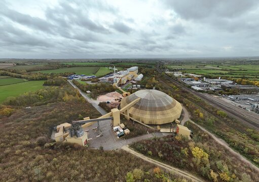 Aerial view of the distinctive dome structure amidst the industrial landscape near Sileby, where autumnal hues meet the stark lines of progress, Sileby, England, United Kingdom.