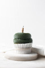 green frosting on cupcakes with a white background, cupcakes in white liners with tall buttercream swirl, green buttercream frosted cupcakes on a white background