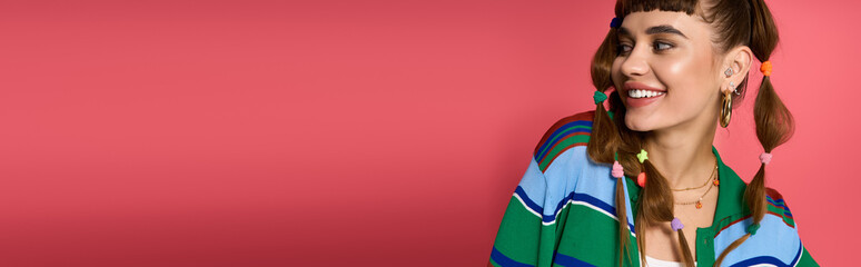 Young woman smiling joyfully with colorful hairstyle in stylish outfit against vibrant background