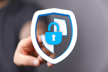 Hand holding a digital shield with a padlock, representing data protection, cybersecurity, and...