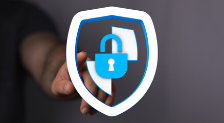 Hand reaching out to touch a digital shield with a padlock, symbolizing data security and internet safety. Concept for protection, pr