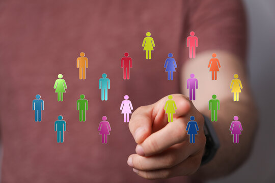 Hand reaching out to connected, colorful digital people, representing concepts of community, networks, teamwork and global connection. Ideal for