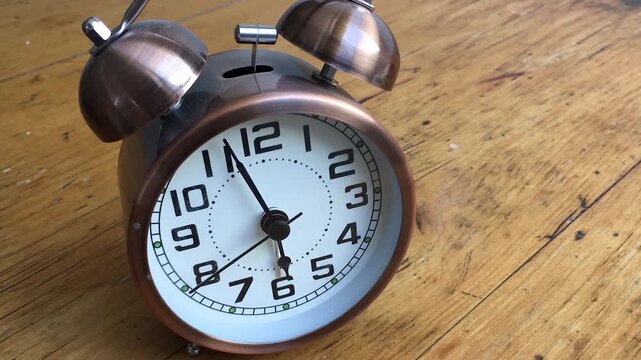 Turn back time .  Alarm clock running backwards fast from 6am 	
