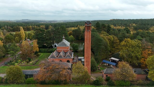 Aerial view of a brick building with a tall chimney standing proudly among the trees and greenery, Nottingham, England, United Kingdom. - Powered by Adobe
