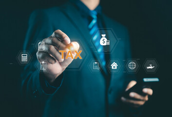 Businessman touching digital tax icon with finance and accounting symbols, representing taxation, financial planning, business management, and online accounting technology concept.
