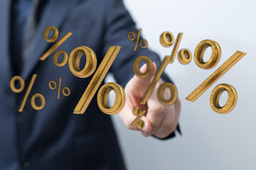 Business professional interacting with golden percentage symbols, visualizing finance, investment, and market growth.