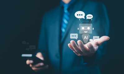 Businessman holding digital AI chatbot icon with speech bubbles, symbolizing artificial intelligence, customer support automation, communication technology, and innovation in modern business.