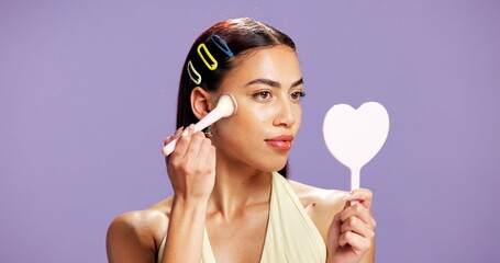 Makeup, mirror and brush woman in studio for cosmetics, contour and beauty maintenance. Self care,...