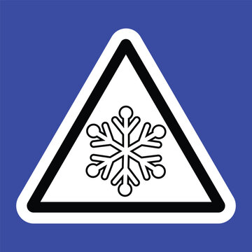 Triangular warning sign with a black snowflake symbol on a white background and blue border, indicating icy or cold surface caution. Ideal for safety signage and winter hazard alerts.