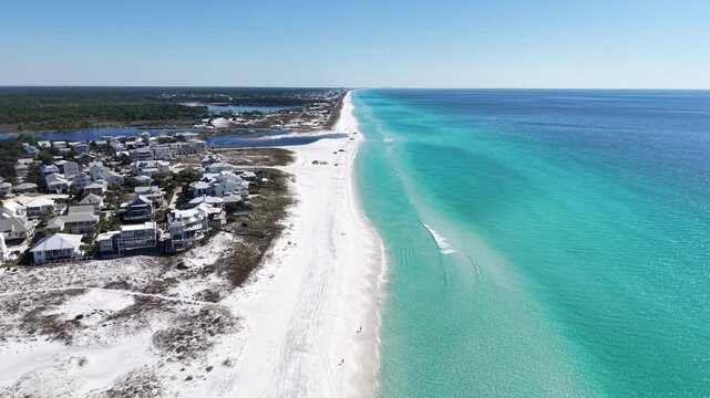 Backward panning drone fly at long coastline of Grayton Beach inhabited area, 30A, Florida, USA