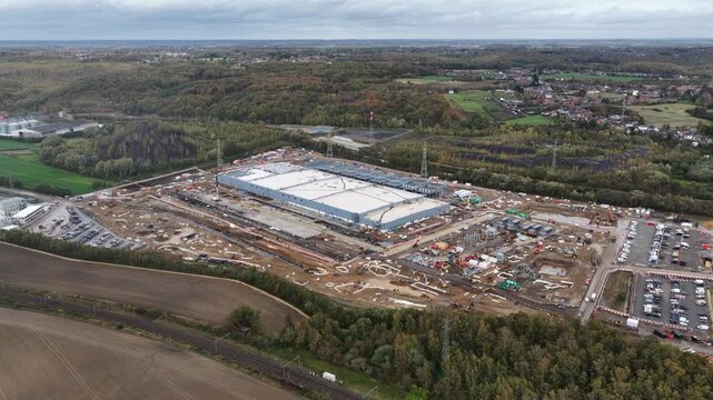 Data center, infrastructure for AI, under construction, Farciennes, Belgium. Aerial drone video.