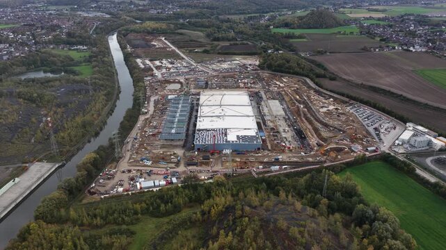 Data center, infrastructure for AI, under construction, Farciennes, Belgium. Aerial drone video.