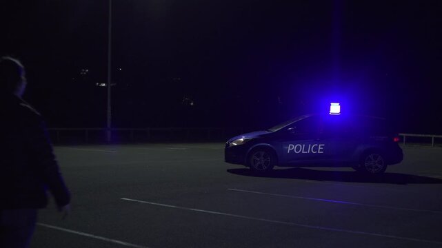 Nighttime footage of a young woman raising her hands and surrendering to police officers under flashing red and blue lights. Dramatic cinematic scene symbolizing law enforcement, justice, and emotion.