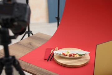 Shooting shrimps with vegetables at table in studio, space for text. Professional food photography