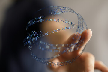 Abstract image of a hand interacting with a digital sphere of code, symbolizing data, technology, and futuristic concepts.